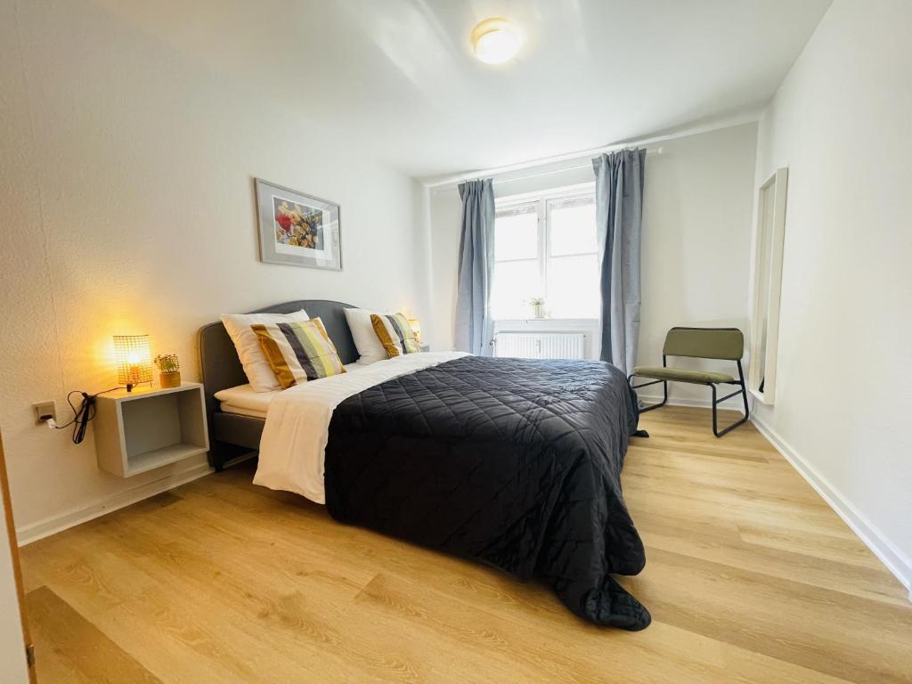 a bedroom with a large bed and a window at aday - Central Terrace Apartment in Hjorring in Hjørring