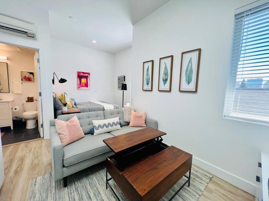 sala de estar con sofá y mesa de centro en Brand New Luxury Fully Furnished Studio Suite en Oakland