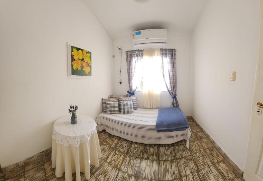 a small room with a bed and a table at Lorena Houses in Capilla del Monte