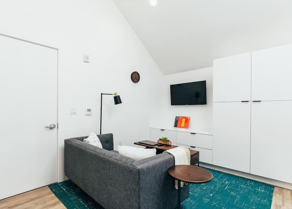 a living room with a couch and a table at Luxury Apt in West Oakland - Near Downtown in Oakland