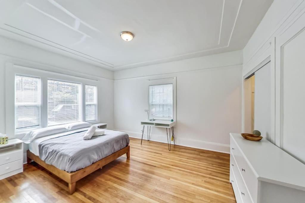 a white bedroom with a bed and a desk at Right Across From Campus 2BR 1b in Berkeley