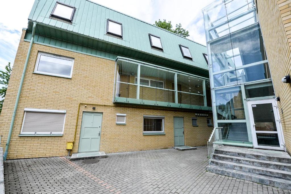 a brick building with blue doors and a window at Riverside Apartments with Sauna in Palanga