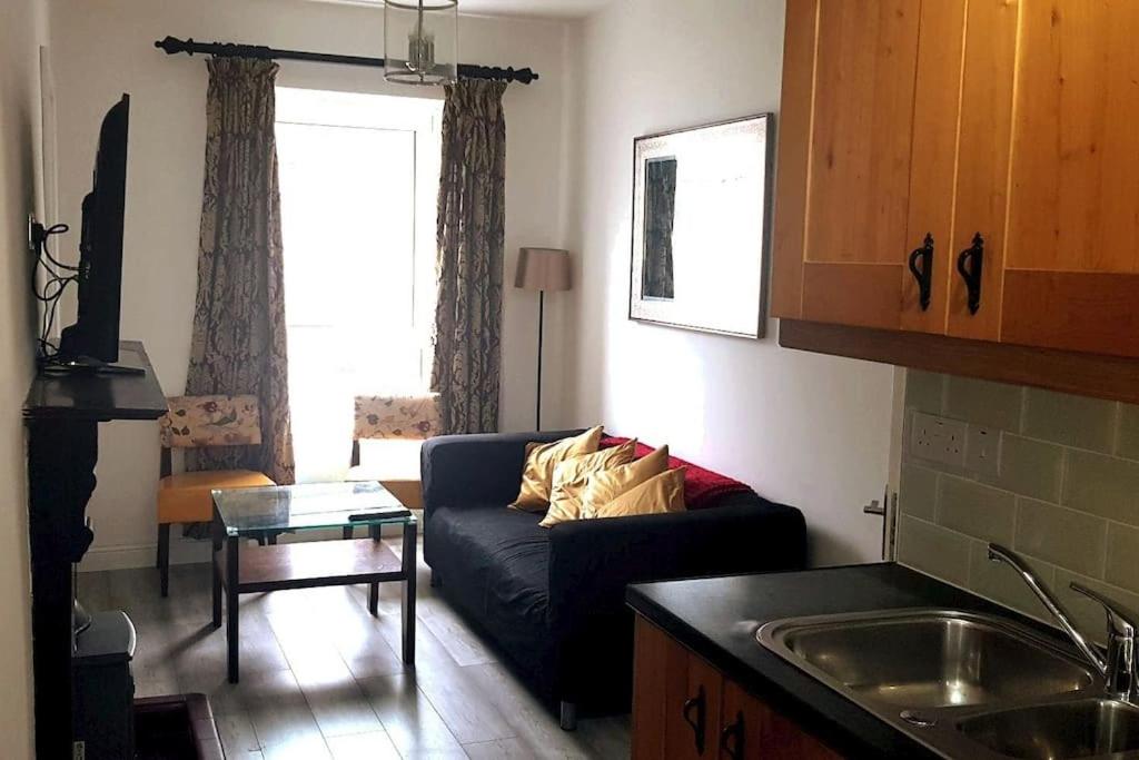 a living room with a couch and a table at Ardara Town centre 2 Bed Apt in Donegal
