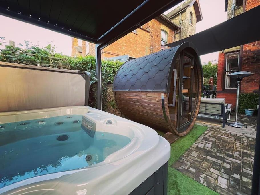 a hot tub in a backyard with a gazebo at Jorvik Villa in York