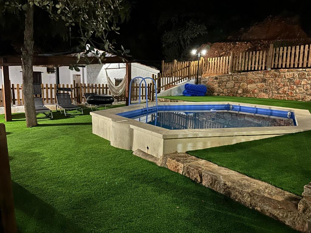 a swimming pool in a yard at night at VILLAS LAS LAGUNAS 1 in Ossa de Montiel