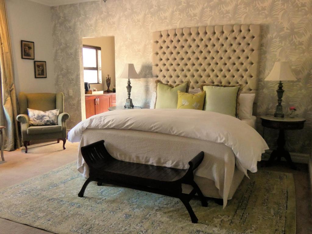 a bedroom with a large bed with a large headboard at 58 On Hume in Johannesburg