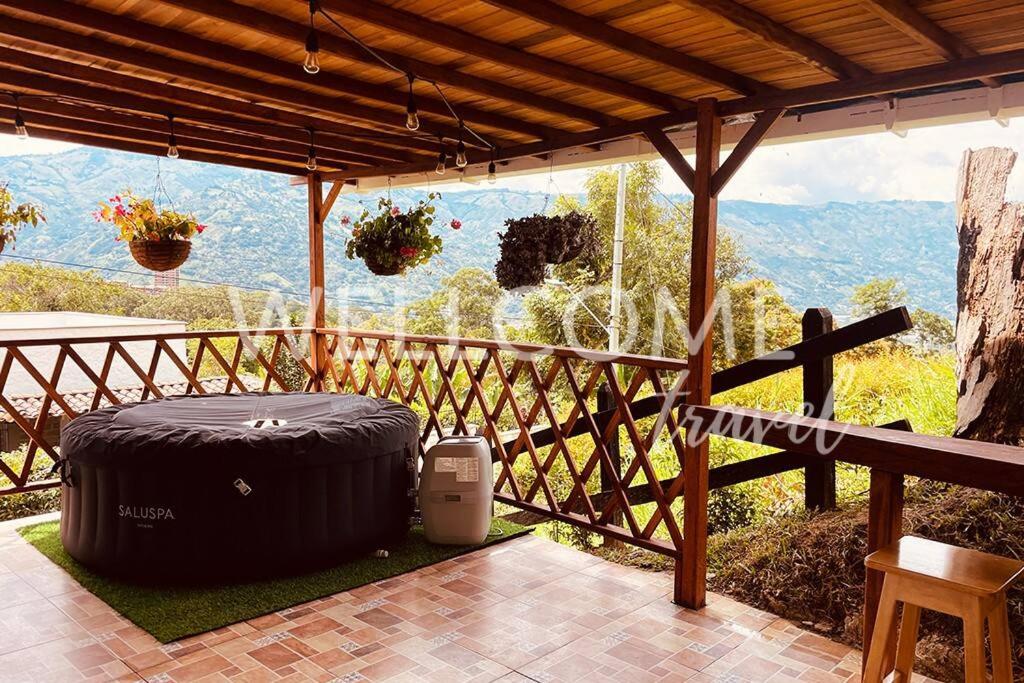 a patio with a large black tire sitting on the ground at Florecita-Cabaña en la montaña Girardota in Girardota