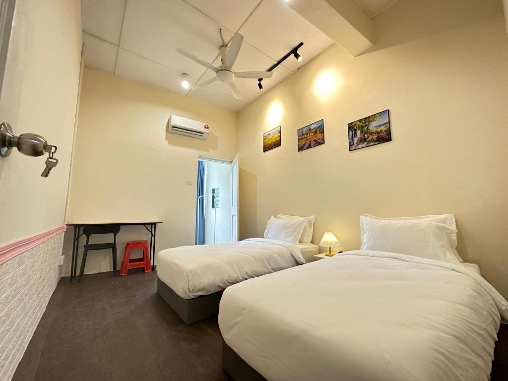 a hotel room with two beds and a window at WW Hostel 22A Private Shower in George Town