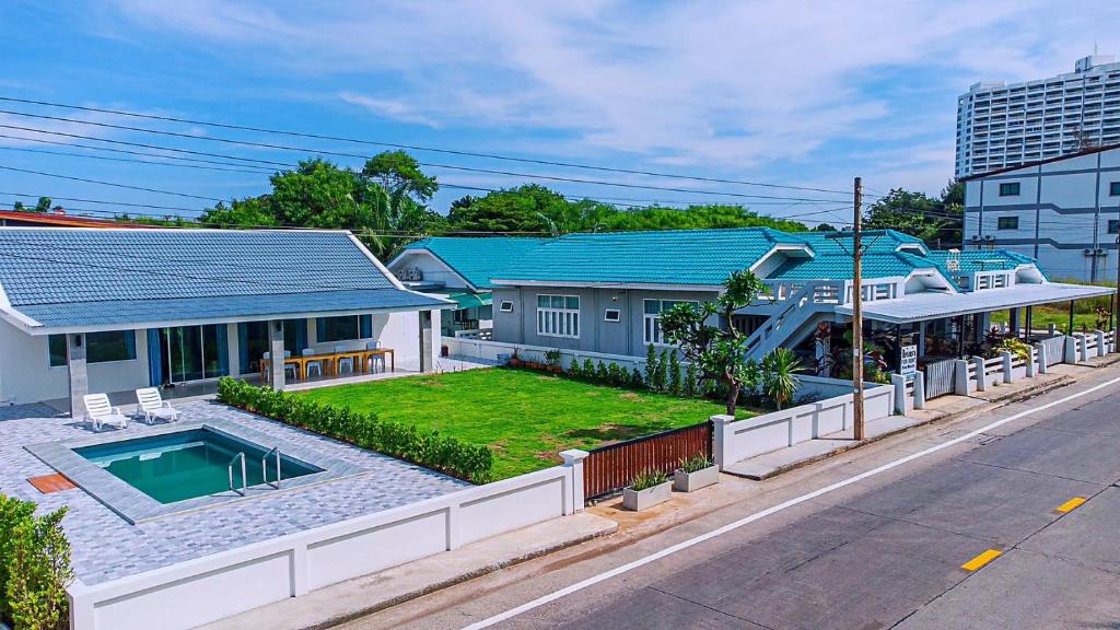 a house with a swimming pool in the middle of a street at Sealife4 Beach Pool Villa in Rayong