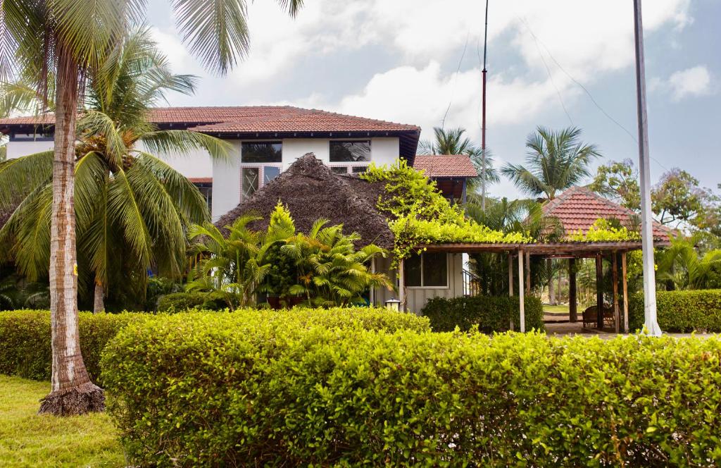 uma casa com uma palmeira e arbustos em Joe's Beach Shack - Beach resort, Ramanathapuram em Mandapam