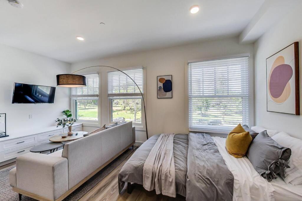 a bedroom with a large bed and a couch at Private Luxury Studio in Lake Merritt in Oakland