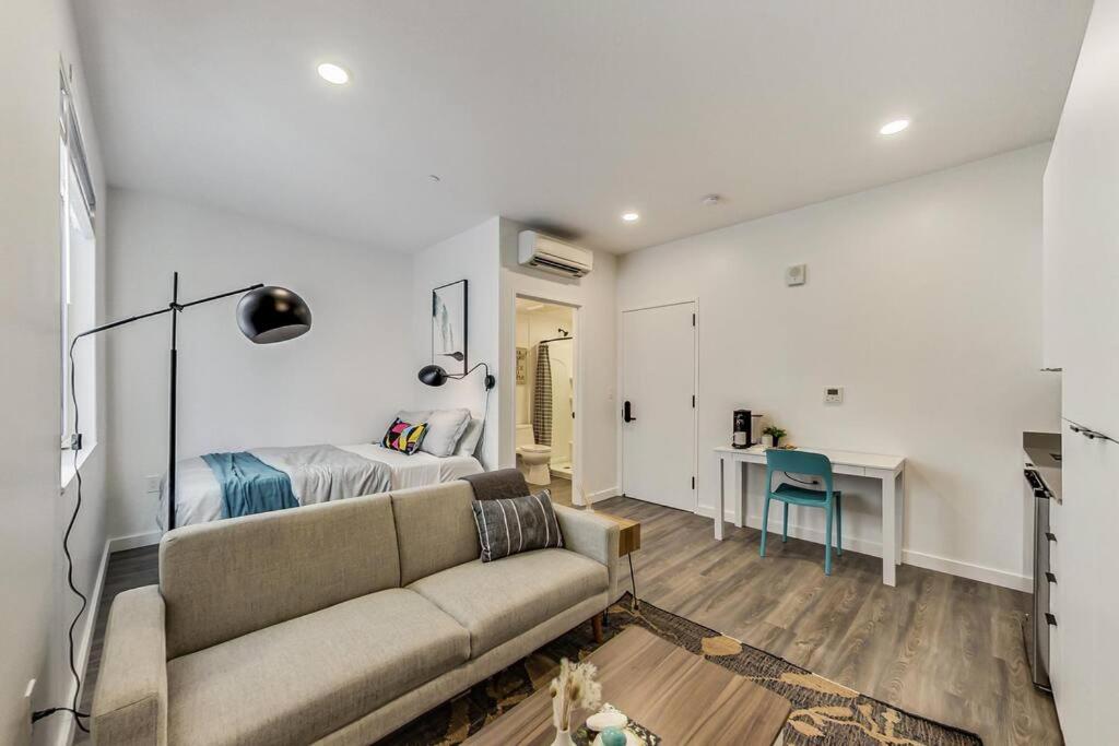 a living room with a couch and a bedroom at New Stylish Studio Suite Near Downtown in Oakland