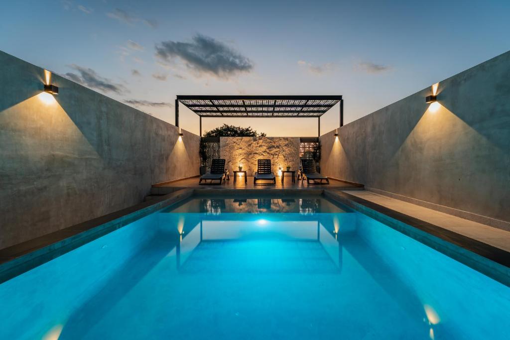 a swimming pool in a house with at Hotel Mexico, Merida in Mérida