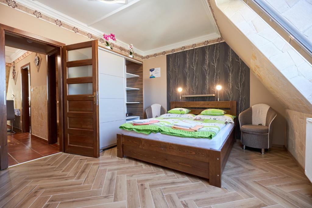 a bedroom with a bed and a staircase at Valentin Deluxe Apartman in Hajdúszoboszló