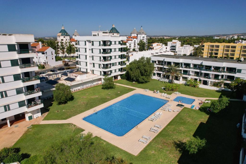 an aerial view of a swimming pool in a city at Centralgarve - Amazing Apt in the Heart of Vilamoura in Vilamoura