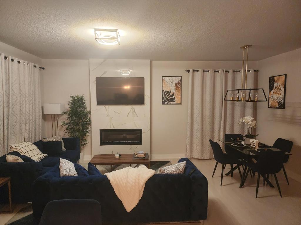 a living room with two blue couches and a table at Dorothy's Deluxe room in Ottawa