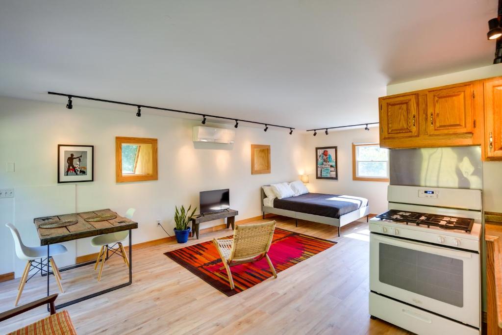 a living room with a kitchen and a couch at 13 Mi to Catamount Mountain Resort: Studio w/ Deck in Claverack