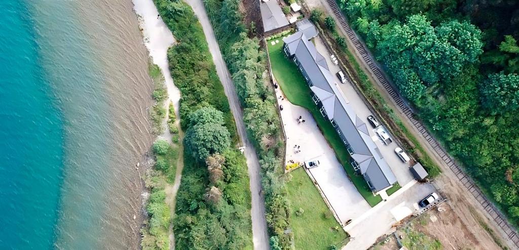 an aerial view of a road next to the water at ApartHotel Kintumay in Puerto Varas