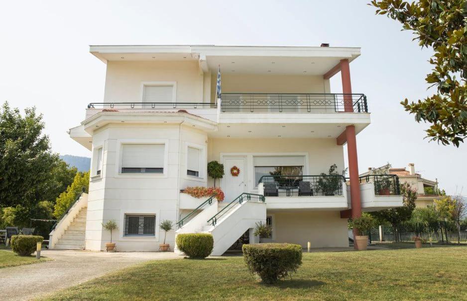 a large white house with stairs on it at Village Villa 
