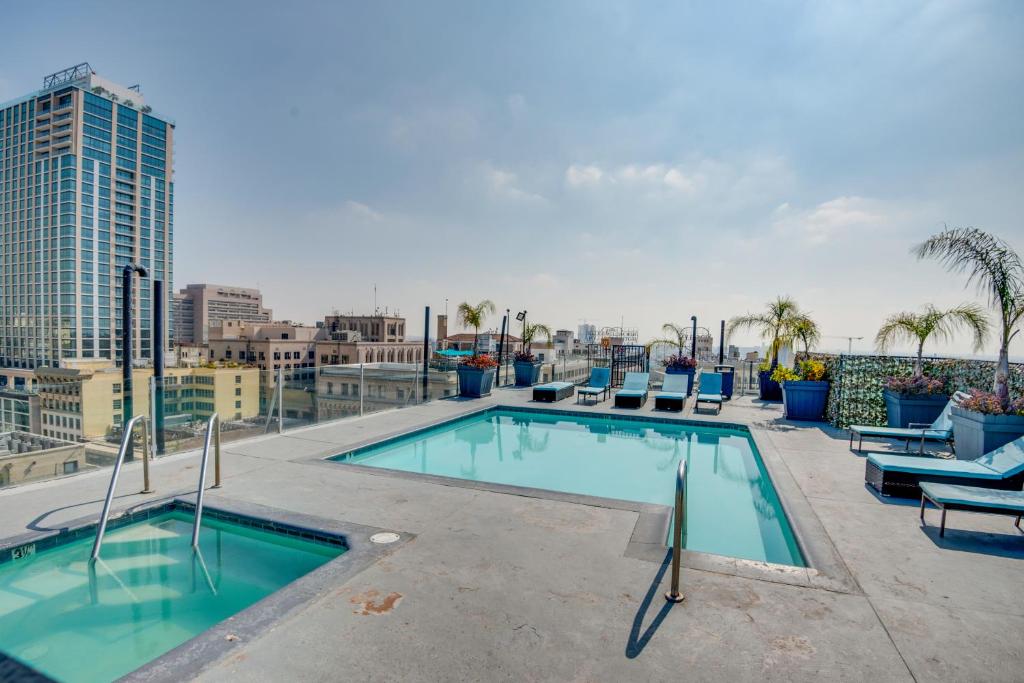 a swimming pool on the roof of a building at Downtown Los Angeles Condo with Shared Rooftop Pool! in Los Angeles