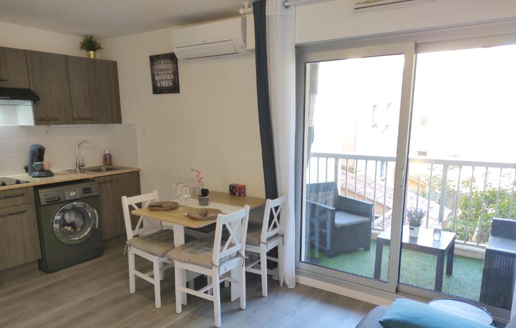 a kitchen and dining room with a table and chairs at Charmant studio climatisé 24 m2 terrasse à 100m de la plage in Saint-Mandrier-sur-Mer