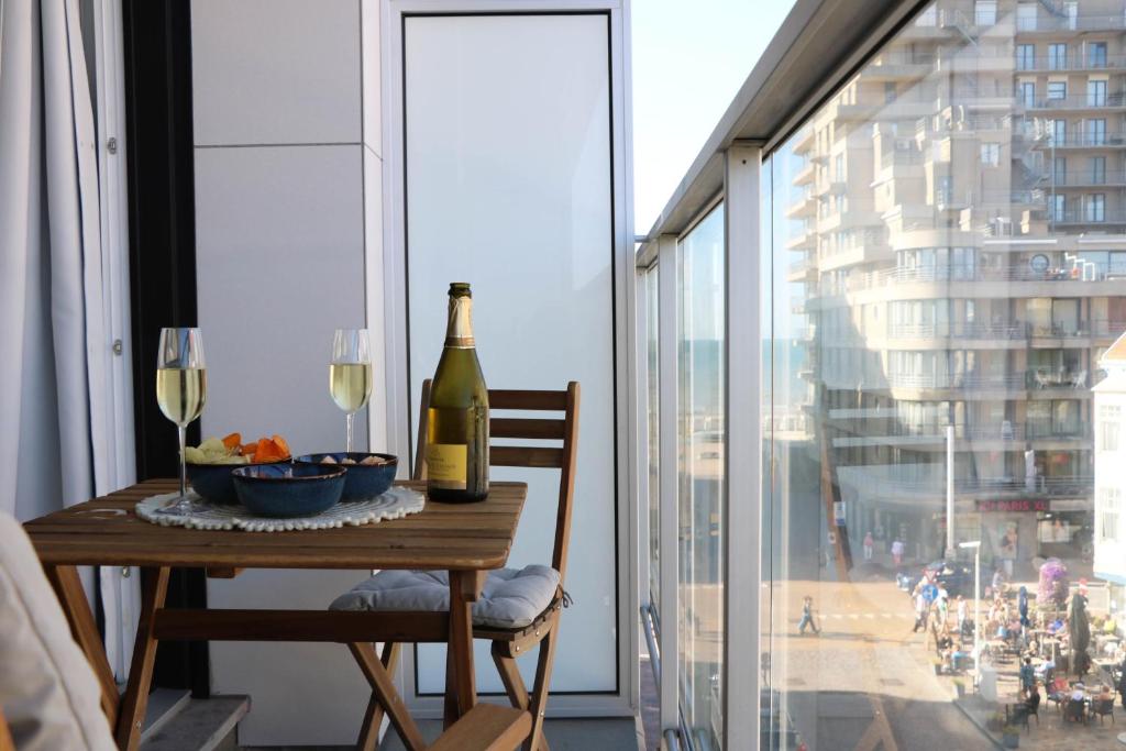 a table with a bottle of wine and a glass at Chez Pascal - Nieuport in Nieuwpoort