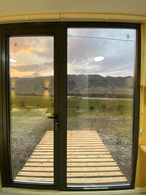 a sliding glass door with a view of the mountains at Panorama Glamping in Saty