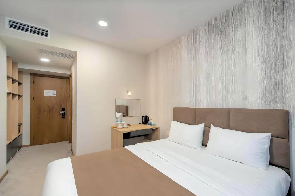 Postel nebo postele na pokoji v ubytování Brooch Boutique Hotel