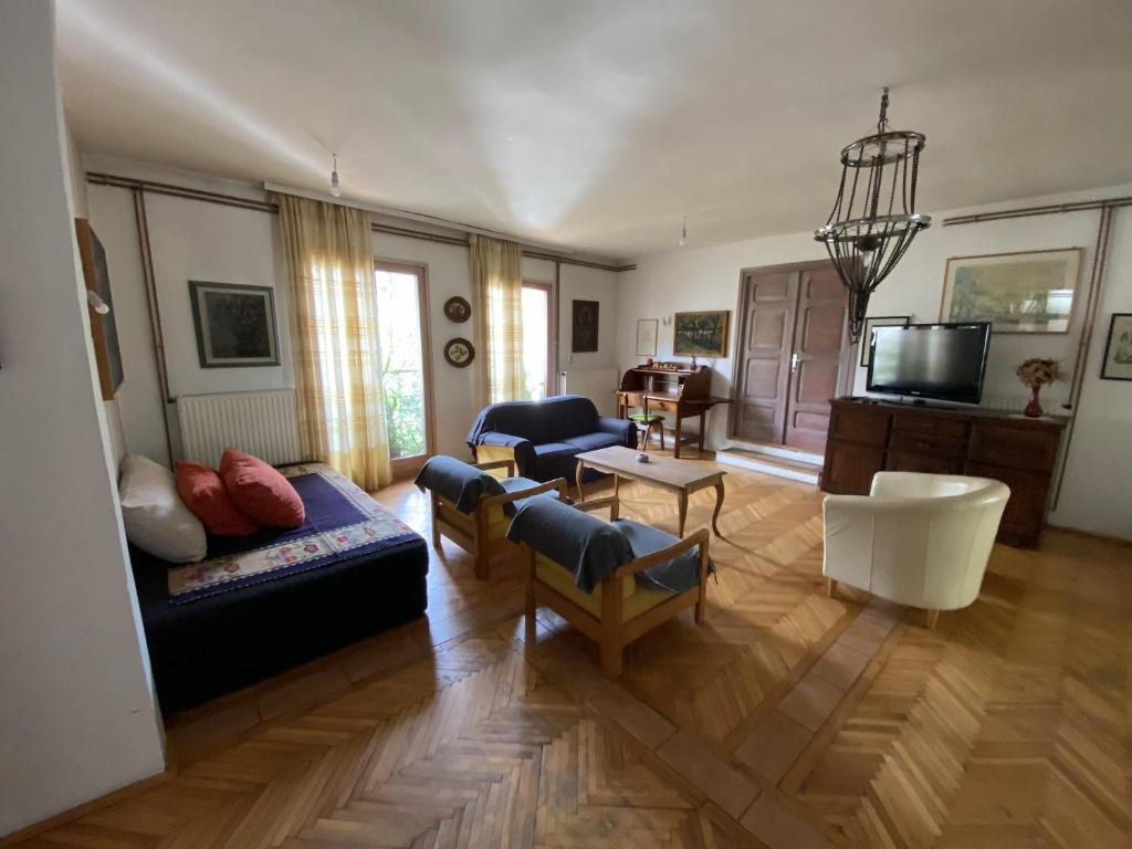 a living room with a couch and a tv at Apartmani SuperStar in Soko Banja
