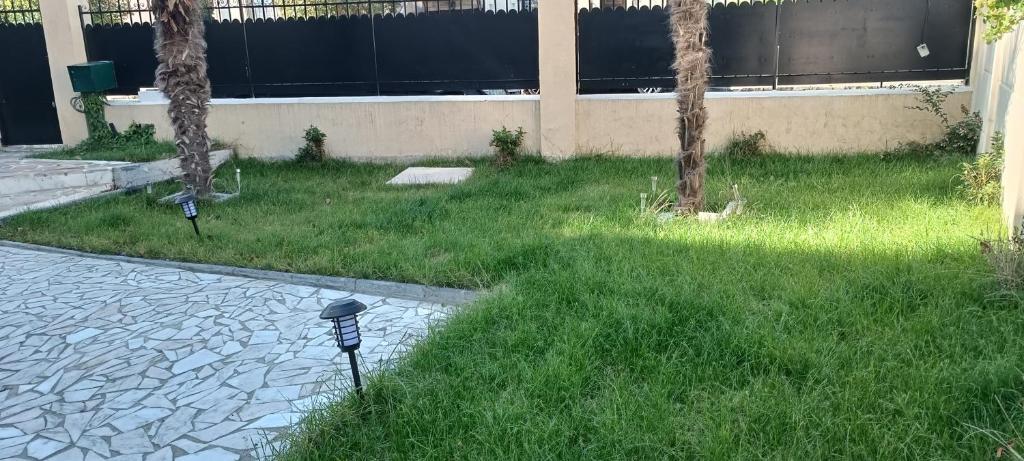 a parking meter in the grass next to a building at calme appartement de vacances in Écouen