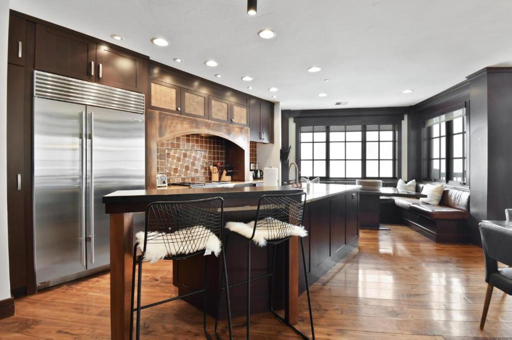 a kitchen with a bar with stools and a fireplace at Flagstaff #301 in Park City