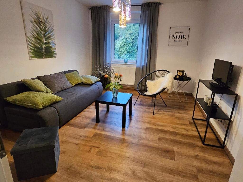 a living room with a couch and a table at FeWo Gabriella in Püttlingen