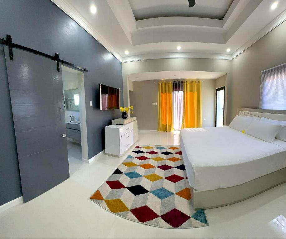 a bedroom with a large bed and a bathroom at Villa Di-Nae in The Rock