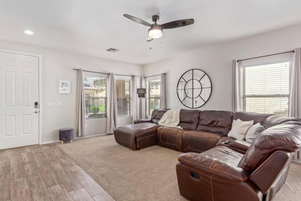 a living room with a couch and a ceiling fan at Sunny Arizona Getaway Your Home Under theDesertSun in Mesa