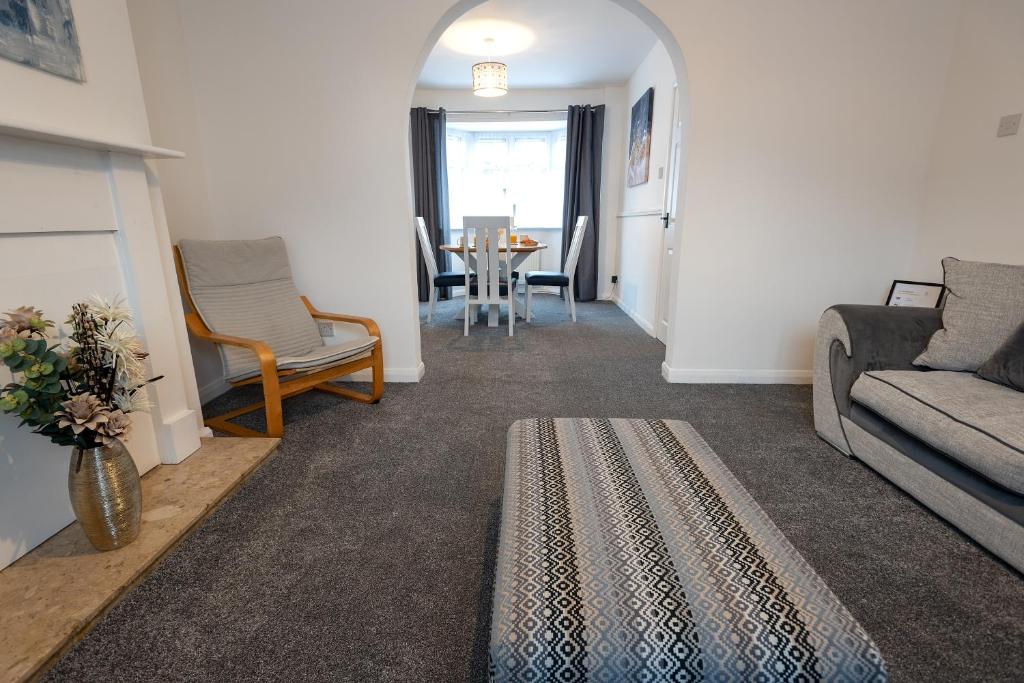 a living room with a couch and a table at Jesmond Square in Hartlepool