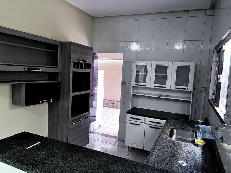 eine Küche mit einer Spüle und einer Theke in der Unterkunft Aluga-se casa mobiliada com wifi in Altamira