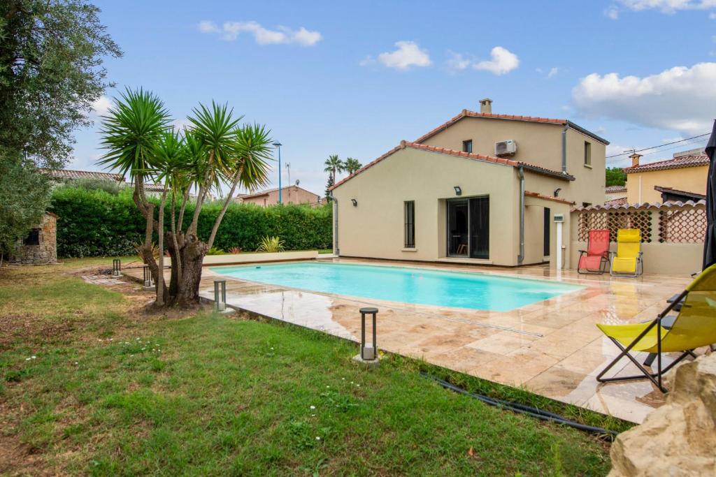 an image of a villa with a swimming pool at Villa Indigo - Welkeys in Mandelieu-la-Napoule