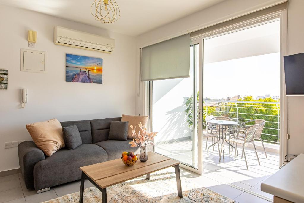 a living room with a couch and a table at Cosy Apart at Lykavitos in Nicosia