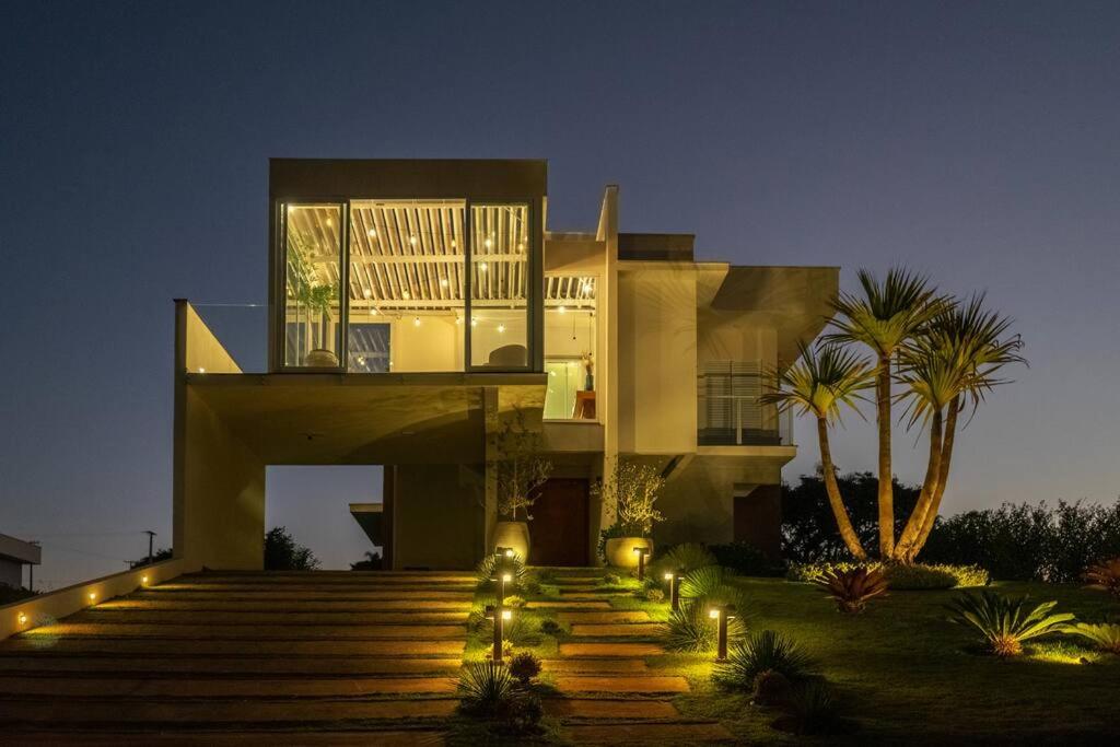 a large house with lights in front of it at Casa alto padrão as margens da represa de Avaré. in Itaí