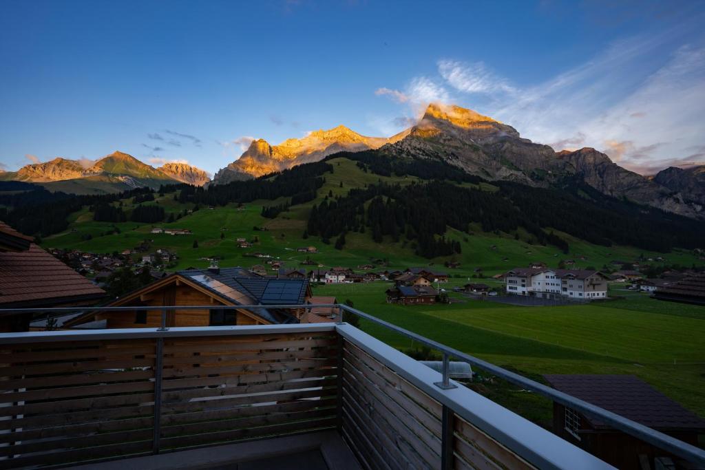 a view of the mountains from the balcony of a house at Chuenislodge1 Neu, grosse Terrasse & Designerofen, prächtige Aussicht in Adelboden