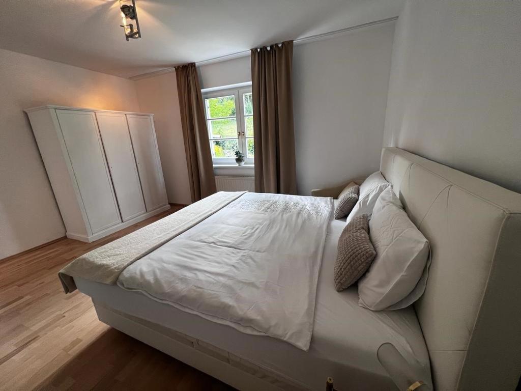 a bedroom with a white bed and a window at Green House bei Baden 