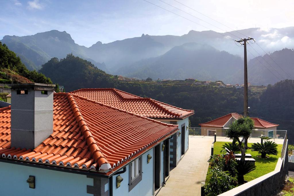 a group of houses with mountains in the background at Casa Da Achada, By OP in São Vicente