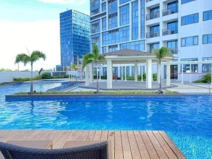 a large swimming pool in front of a building at Mactan Cebu Beach Condo in Punta Engaño