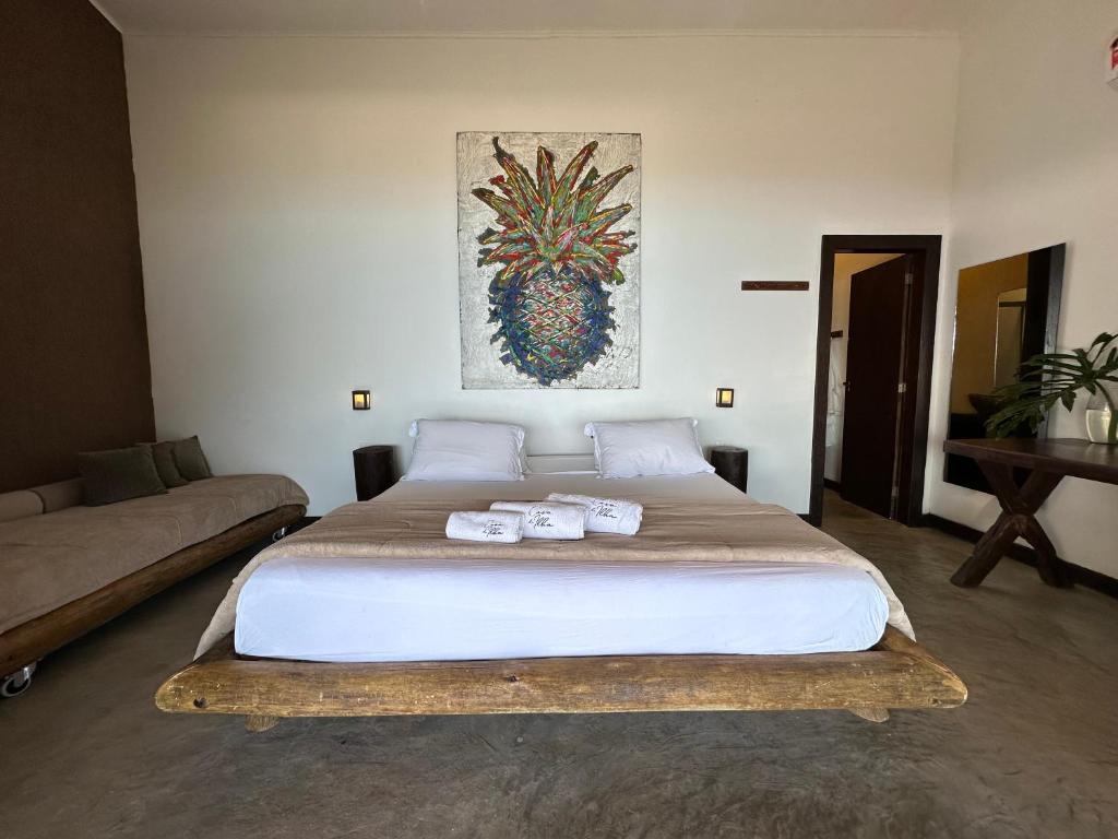 a bedroom with a large bed with towels on it at Casa da Ilha in Praia de Araçatiba