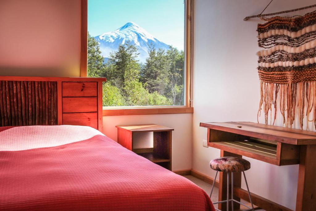 a bedroom with a view of a snow covered mountain at Hamilton's Place Bed and Breakfast in La Ensenada