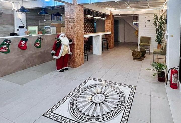 a store with santa claus standing in the middle of a lobby at UrbanView at Balzain East Tuguegarao City by RedDoorz in Tuguegarao City