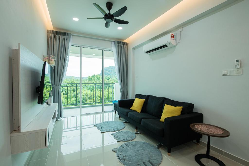 sala de estar con sofá y balcón en BB Condo Homestay, en Sandakan