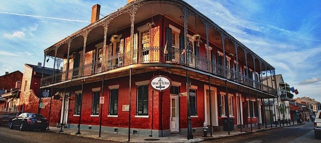 a red building on the side of a street at Inn on St. Peter, a French Quarter Guest Houses Property in New Orleans