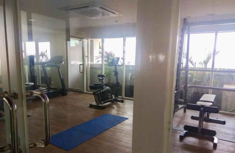 a gym with treadmills and ellipticals in a room at Grand Kamala Lagoon Bekasi Apartement - Type Studio in Pulosirih
