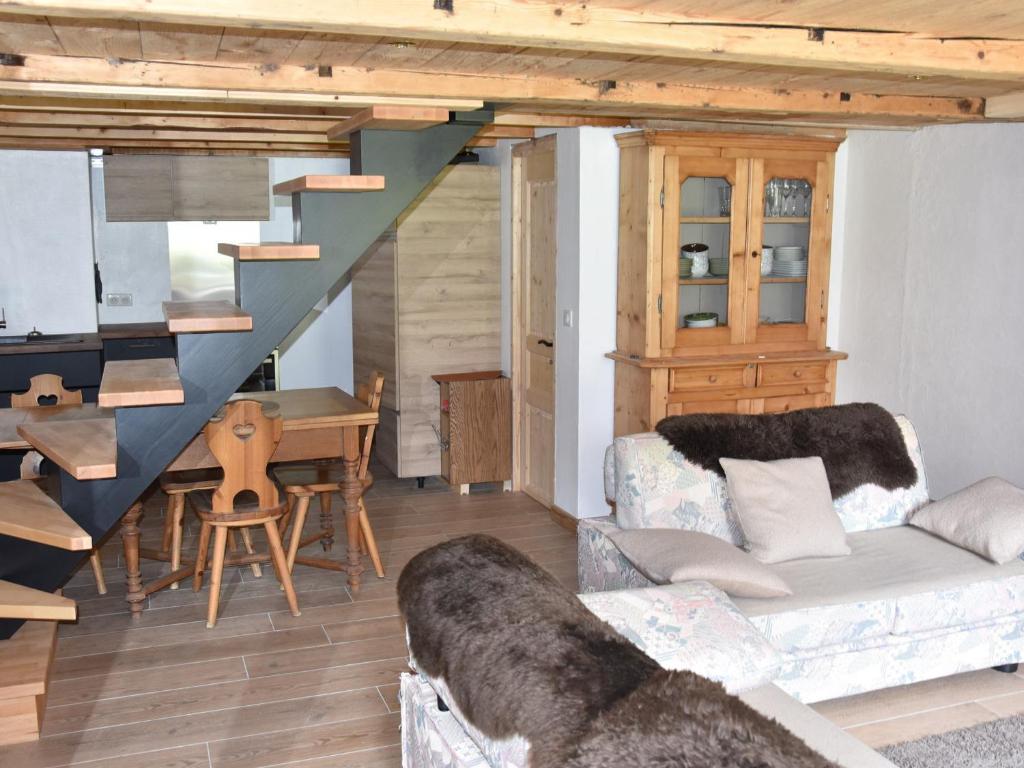 a living room with a couch and a staircase at Chalet Pralognan-la-Vanoise, 3 pièces, 4 personnes - FR-1-464-219 in Pralognan-la-Vanoise